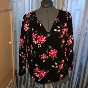A black shirt that has flowers on it